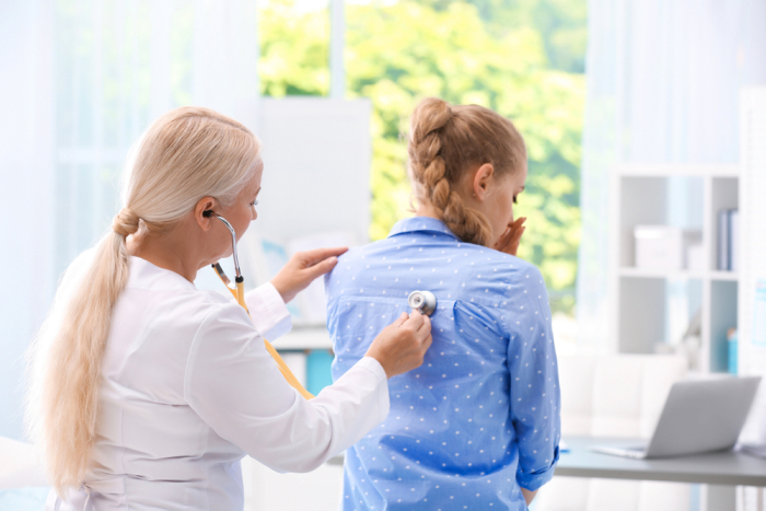 doctor listening to patient's lungs